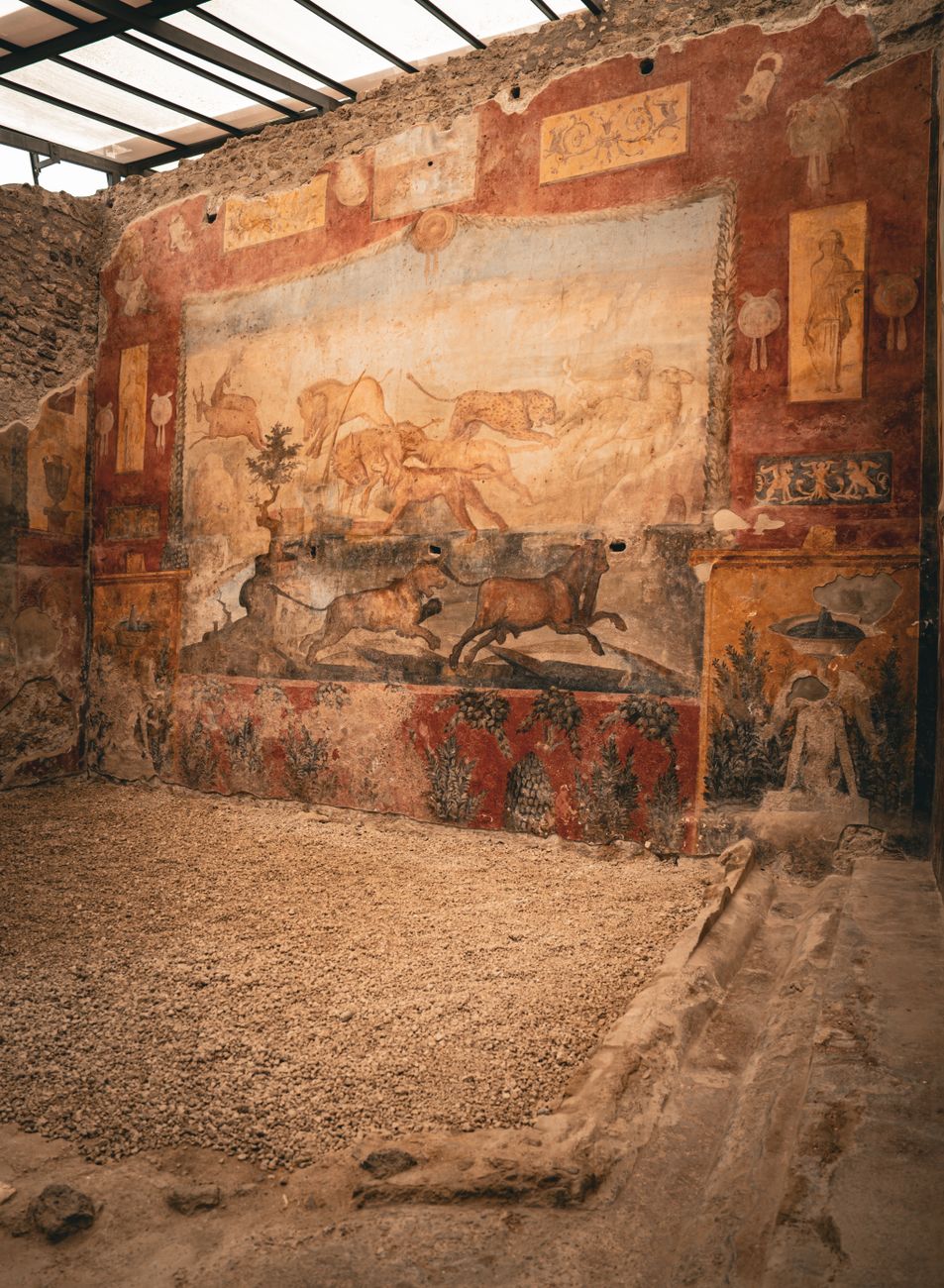 Detailed view of ancient fresco art on a wall in Pompeii, showcasing Roman history and architecture.
