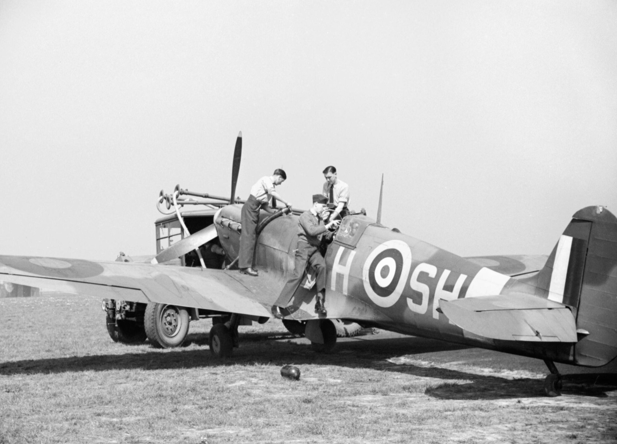 Ground staff refuel a Supermarine Spitfire Mk VB of No. 64 Squadron RAF at Hornchurch, 7 May 1942. This image is part of a sequence of five photographs taken on 7 May 1942 at Hornchurch, and later released by the Ministry of Information to illustrate a typical offensive operation. In the bright spring sunshine, a No 64 Squadron Spitfire VB is readied for another sortie.