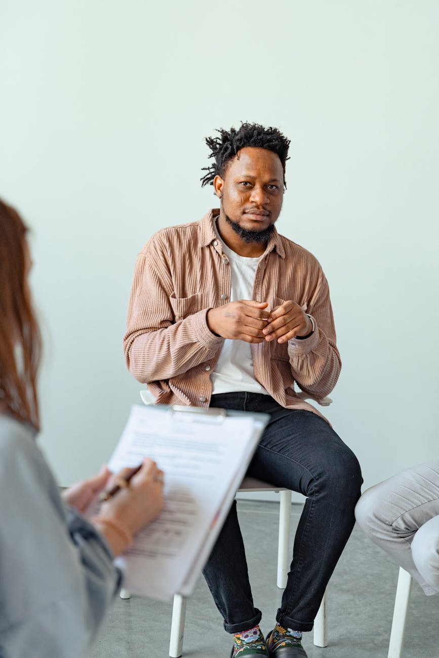 Therapist and client engaged in a counseling session to discuss mental health.